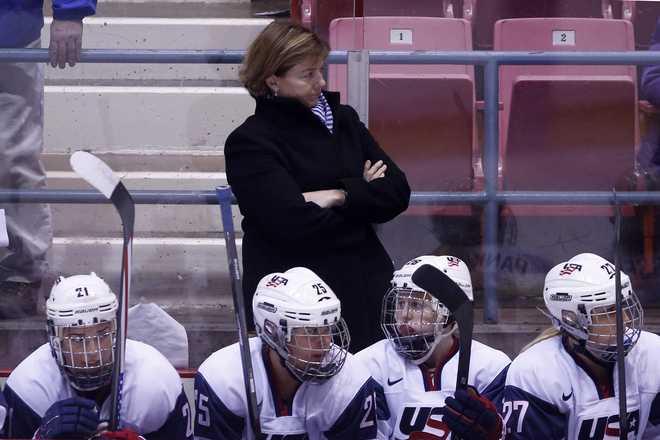 United head coach Katie Stone watches the game from the bench during the first period of the Four Nations Cup during the Omen's hockey game against Canada in Lake Placid, N.Y., Wednesday, Nov. 6, 2013. AP photo by Mike Grohl