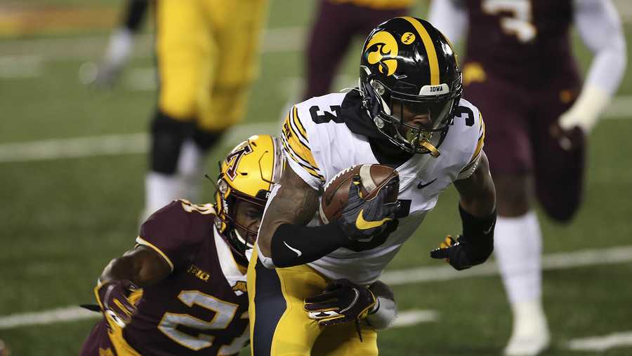 Iowa wide receiver Tyrone Tracy Jr. (3) carries the ball in front of Minnesota defensive back Justus Harris (21) during the first half of an NCAA college football game Friday, Nov. 13, 2020, in Minneapolis. (AP Photo/Stacy Bengs)