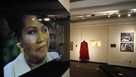 In a photo from Friday, Sept. 21, 2018, in Detroit, an exhibit at the Charles H. Wright Museum of African American History features a "tribute to the Queen of Soul." "THINK" opens to the public Tuesday at the museum that hosted Aretha Franklin's public visitations after her death last month. It features archival photographs, videos and the red shoes she wore at her first visitation that drew global attention. 