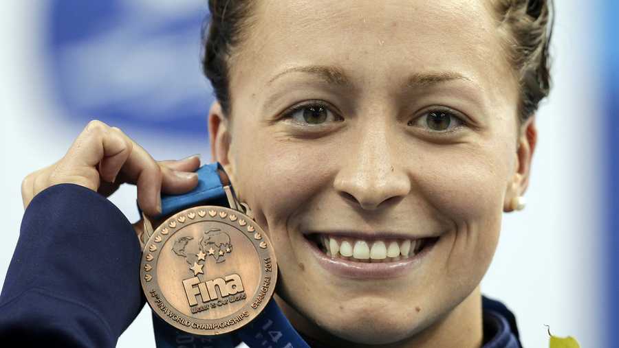 In this July 25, 2011, file photo, Ariana Kukors, of the United States, holds her bronze medal for the women's 200-meter Individual Medley final at the FINA 2011 Swimming World Championships in Shanghai, China.