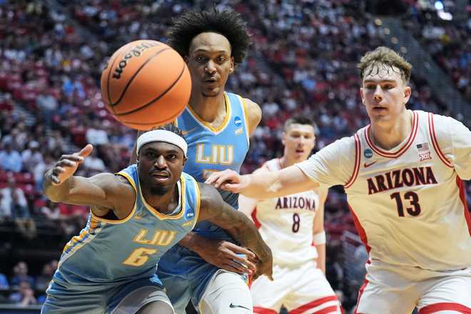 LIU forward Mason Porter-Brown (6) reaches for the ball in front of center Isaiah Miranda, middle, and Arizona center Motiejus Krivas (13) during the first half in the first round of the NCAA college basketball tournament, Friday, March 20, 2026, in San Diego.