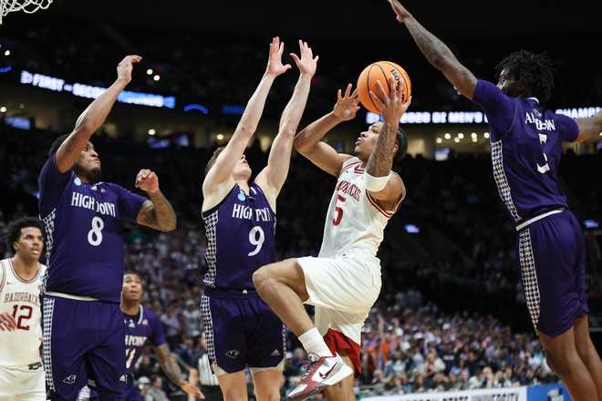 Arkansas guard Darius Acuff Jr. (5) goes to the basket over High Point guard Conrad Martinez (9) during the second half in the second round of the NCAA college basketball tournament Saturday, March 21, 2026.