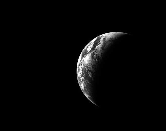 This black and white image of Earth was captured by the optical navigation sensor on the exterior of the Orion spacecraft on the first day of the Artemis II mission.