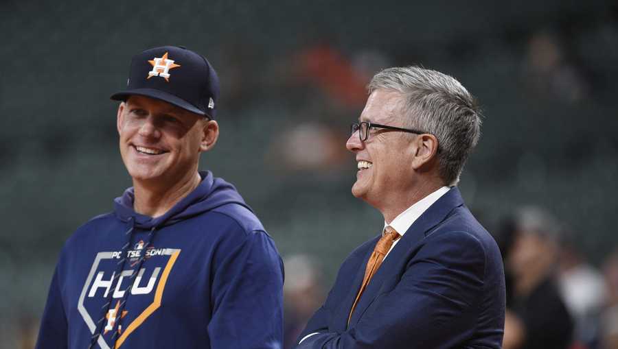 Houston Astros manager AJ Hinch, left, and general manager Jeff Luhnow, right, before Game 2 of a best-of-five American League Division Series baseball game against the Tampa Bay Rays in Houston, Saturday, Oct. 5, 2019.