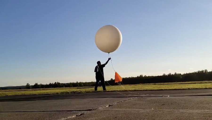 A National Weather Service forecaster in Caribou launches one of 6 weather balloons the office is sending into the skies each day.