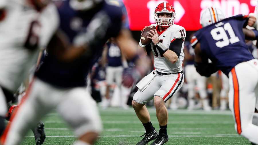 Jake Fromm, #11 of the Georgia Bulldogs, drops back to pass during the first half against the Auburn Tigers in the SEC Championship at Mercedes-Benz Stadium on December 2, 2017 in Atlanta, Georgia. 
