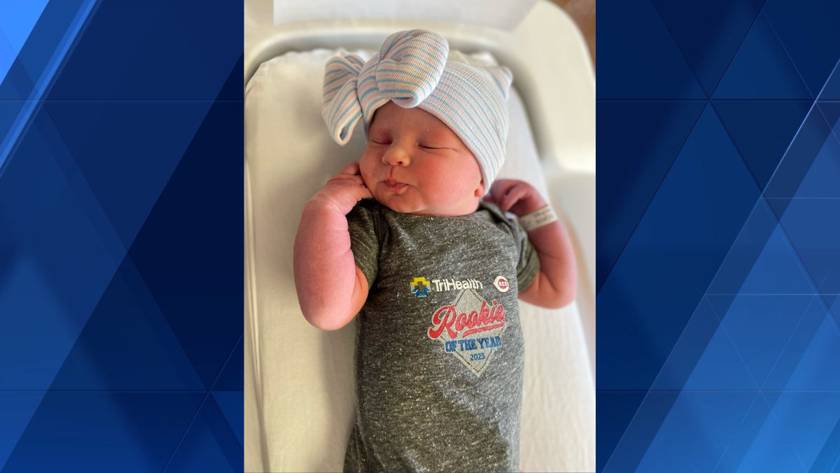 TriHealth celebrating Opening Day with Reds onesies for newborns