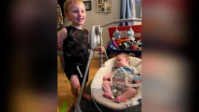 Milo&#x20;Alligood,&#x20;right,&#x20;meets&#x20;his&#x20;older&#x20;brother,&#x20;Eli,&#x20;for&#x20;the&#x20;first&#x20;time&#x20;in&#x20;their&#x20;Adams,&#x20;Massachusetts&#x20;home&#x20;on&#x20;July&#x20;27,&#x20;2021.&#x20;Milo&#x20;spent&#x20;the&#x20;first&#x20;7&#x20;months&#x20;of&#x20;his&#x20;life&#x20;in&#x20;hospital&#x20;care&#x20;due&#x20;to&#x20;a&#x20;rare&#x20;genetic&#x20;disorder.