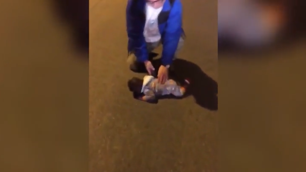 Mother arrested after video of infant crawling through street goes viral