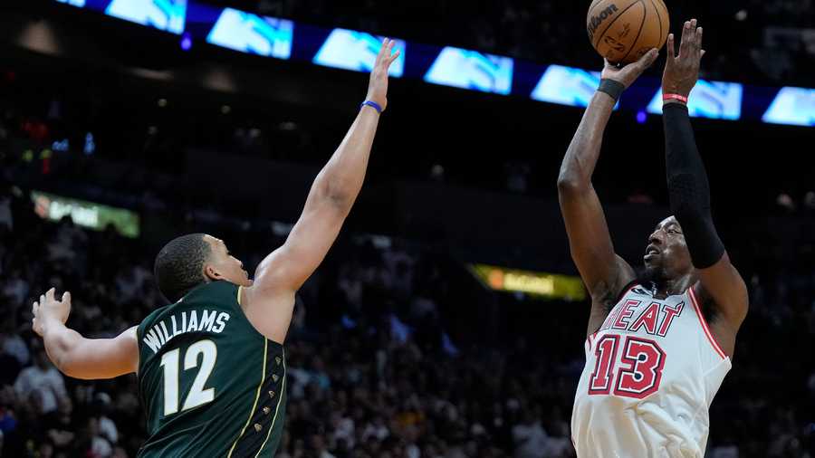 Miami Heat center Bam Adebayo (13) makes a shot against Boston Celtics forward Grant Williams (12) during the final seconds of second half of an NBA basketball game, Tuesday, Jan. 24, 2023, in Miami.