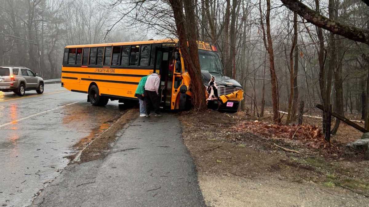 Mass. man charged after crash sends school bus with students into tree