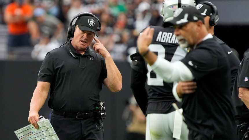 Las Vegas Raiders head coach Jon Gruden speaks on his headset during the first half of an NFL football game against the Chicago Bears, Sunday, Oct. 10, 2021, in Las Vegas. (AP Photo/Rick Scuteri)