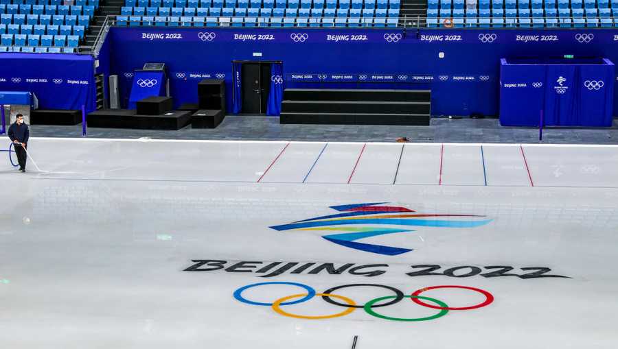 Workers prepare the ice, as technicians and photographers tour the Beijing Capitol Indoor Stadium on media walk through day ahead of the Beijing Winter Olympics on January 12, 2022 in Beijing, China. (