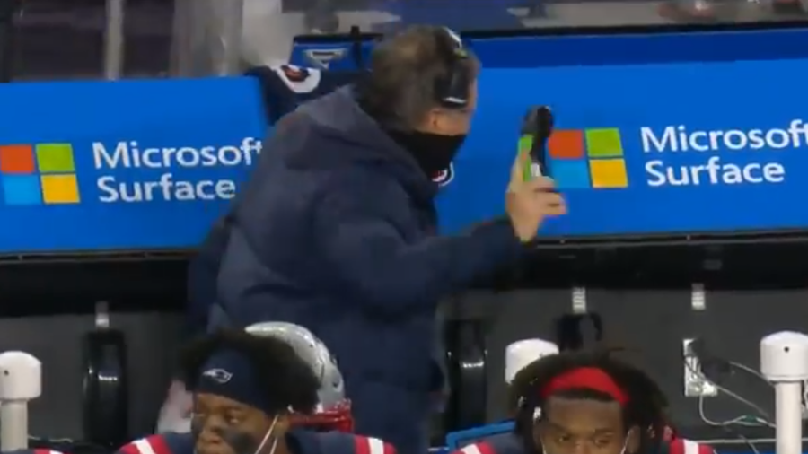 New England Patriots Head Coach Bill Belichick throws a phone during the Monday Night Football game