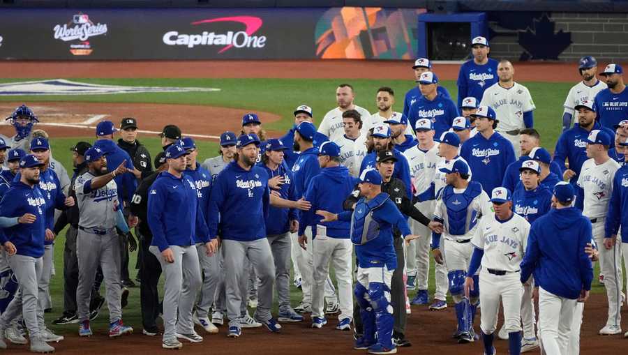 The Los Angeles Dodgers and the Toronto Blue Jays benches clear after Blue Jays&apos; Andrés Giménez was hit by a pitch during the fourth inning in Game 7 of baseball&apos;s World Series, Saturday, Nov. 1, 2025, in Toronto.
