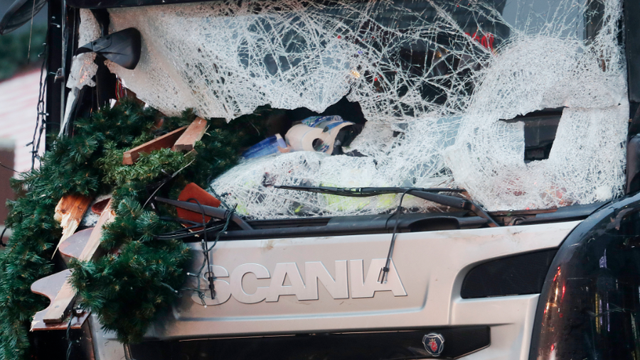 Christmas decoration sticks in the smashed window of the cabin of a truck which ran into a crowded Christmas market Monday evening killing several people in Berlin, Germany, Tuesday, Dec. 20, 2016. 