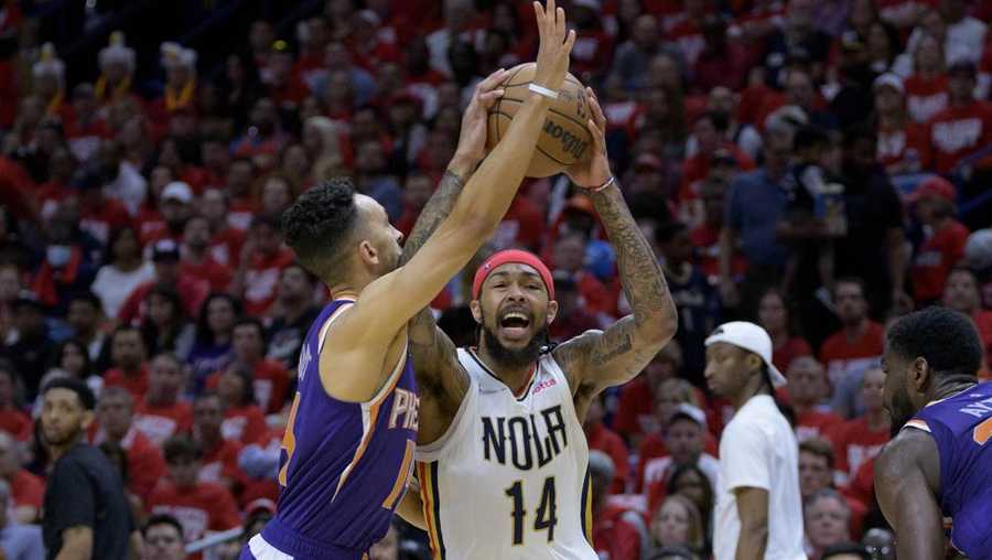 new orleans pelicans forward brandon ingram (14) shoots against phoenix suns guard landry shamet in the first half of game 4 of an nba basketball first-round playoff series in new orleans, sunday, april 24, 2022. (ap photo/matthew hinton)