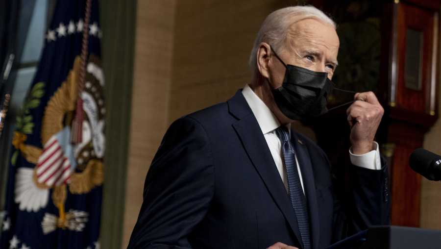 In this Wednesday, April 14, 2021, file photo, President Joe Biden removes his mask to speak at a news conference at the White House, in Washington.