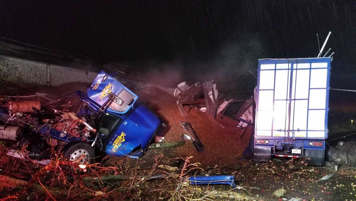 Big rig sheers off road sign, crashes off Highway 50