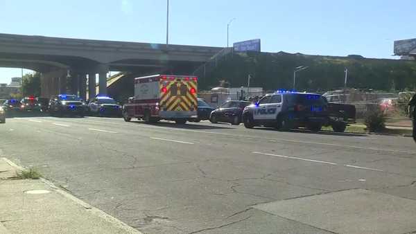 Police and first responders at a shooting scene near an interstate