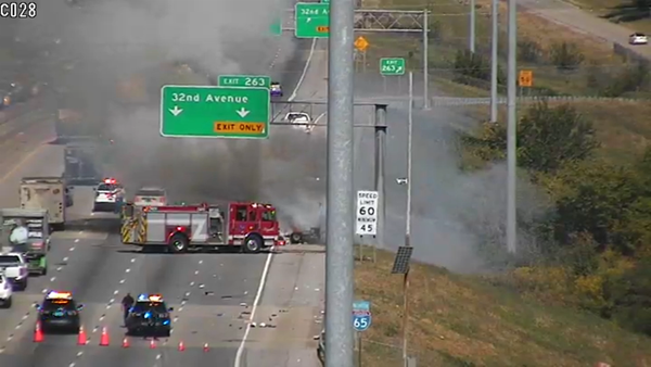 Fire truck next to a fire on an interstate