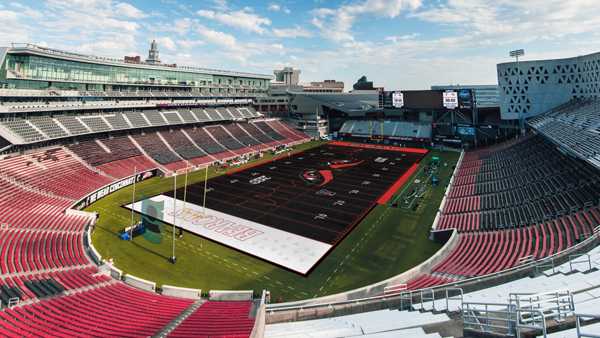 No, Cincinnati Bearcats will not play on a black football field Friday