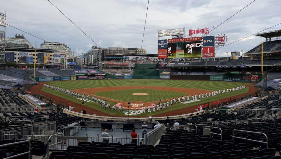 The New York Yankees and the Washington Nationals kneel during a moment of silence for Black Lives Matter prior to the game at Nationals Park on July 23, 2020 in Washington, D.C.