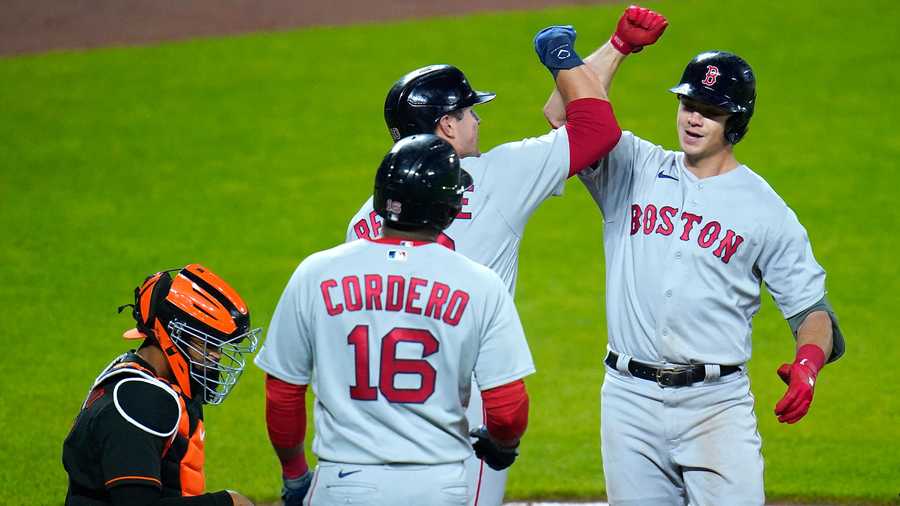 Boston Red Sox's Bobby Dalbec, right, is greeted near home plate by Hunter Renfroe, center, and Franchy Cordero (16) after he scored all of them on a three-run home run off Baltimore Orioles starting pitcher Matt Harvey during the fourth inning of a baseball game, Friday, May 7, 2021, in Baltimore. Orioles' catcher Pedro Severino, left, looks on. (AP Photo)