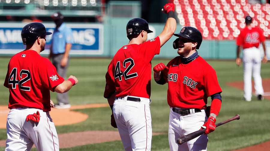 Boston Red Sox's Bobby Dalbec, center, celebrates his two-run home run with Alex Verdugo, right, that also drove in Kevin Plawecki, left, during the third inning of a baseball game against the Washington Nationals, Sunday, Aug. 30, 2020, in Boston. (AP Photo/Michael Dwyer)