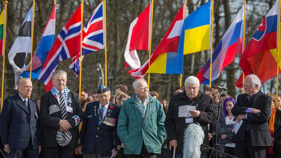 This picture taken on April 12, 2015 and handed out on March 21, 2022 by the Buchenwald and Mittelbau-Dora Memorials Foundation shows Holocaust survivor Boris Romanchenko (2nd R) as he stands next to other former prisoners of the Buchenwald Nazi concentration camp during a commemoration ceremony at the camp's memorial site in Buchenwald near Weimar, eastern Germany.
