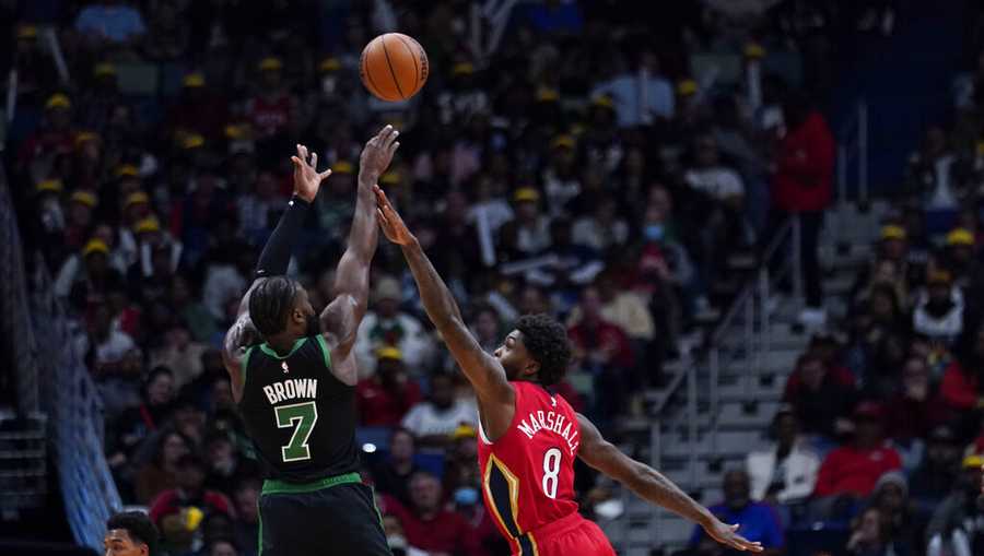 Boston Celtics guard Jaylen Brown (7) shoots against New Orleans Pelicans forward Naji Marshall (8) in the first half of an NBA basketball game in New Orleans, Friday, Nov. 18, 2022. (AP Photo/Gerald Herbert)