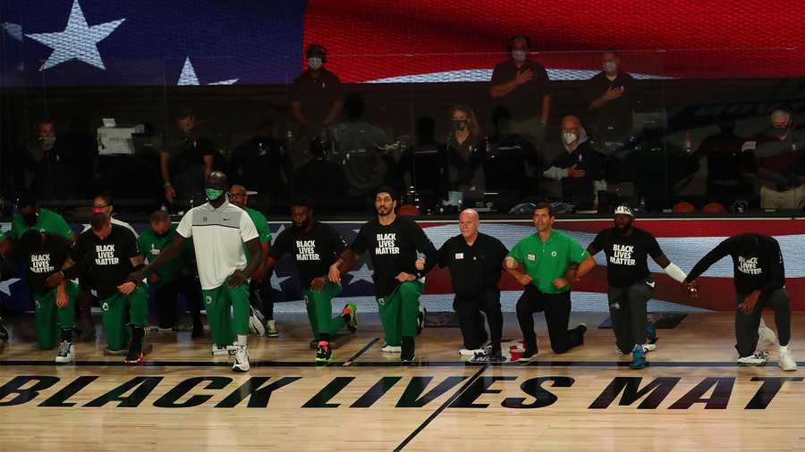 Boston Celtics players kneel during the national anthem before an NBA basketball game against the Orlando Magic, Sunday, Aug. 9, 2020, in Lake Buena Vista, Fla. (Kim Klement/Pool Photo via AP)