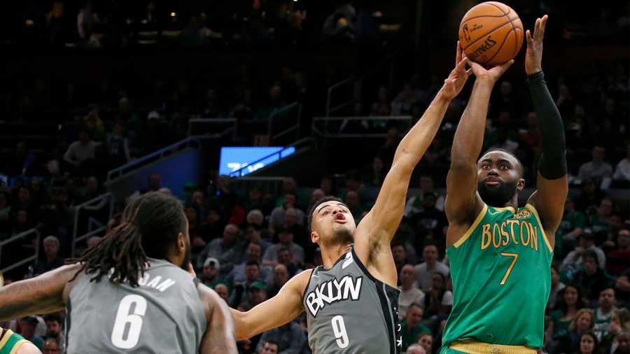 Boston Celtics guard Jaylen Brown (7) shoots over Brooklyn Nets guard Timothe Luwawu-Cabarrot (9) during the second half of an NBA basketball game Tuesday, March 3, 2020, in Boston. (AP Photo)