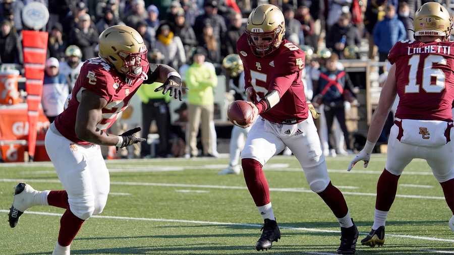 Boston College quarterback Phil Jurkovec (5) hands the ball off to running back Pat Garwo III (24) during the first half of an NCAA college football game against Wake Forest, Saturday, Nov. 27, 2021, in Boston. (AP Photo)
