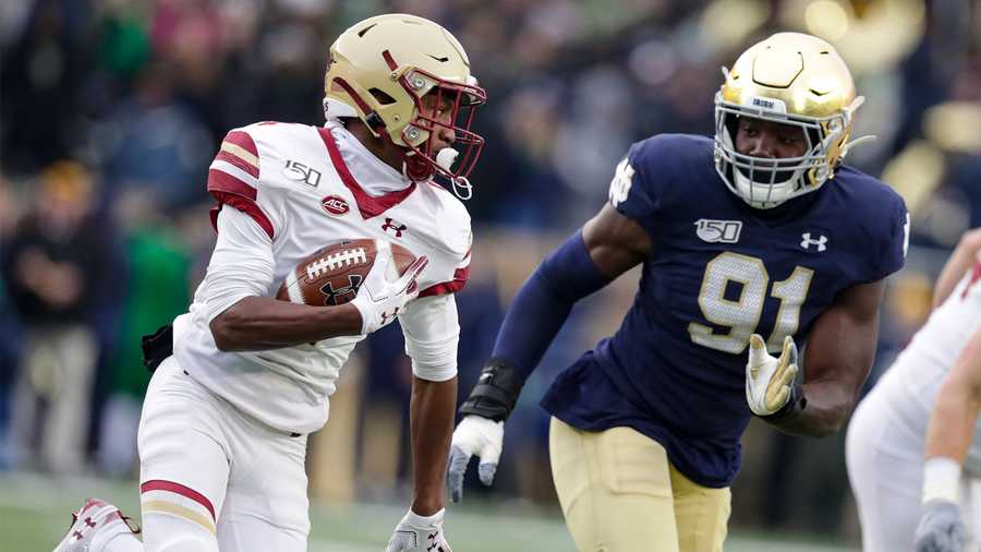 Boston College wide receiver Zay Flowers (4) cuts around Notre Dame defensive lineman Adetokunbo Ogundeji (91) during the first half of an NCAA college football game in South Bend, Ind., Saturday, Nov. 23, 2019. (AP Photo/Michael Conroy)