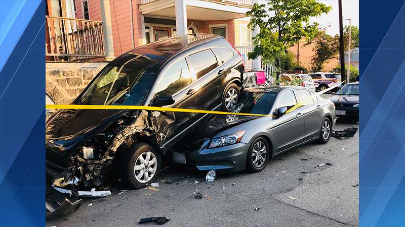 SUV ends up on top of car after crash in Boston