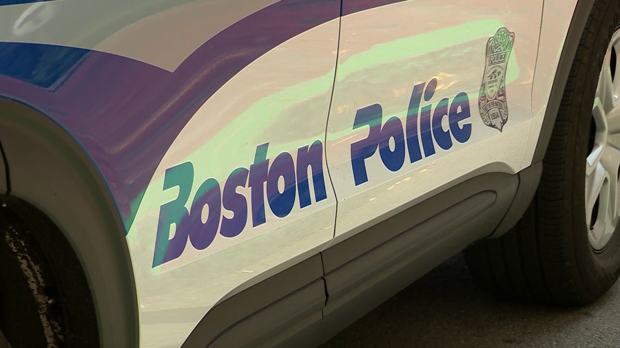 A close up photo of the words "Boston Police" on the side of a cruiser