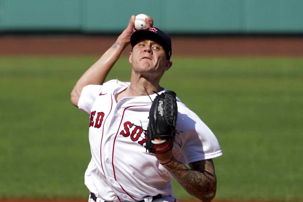 Tanner Houck of the Boston Red Sox warms up before the first