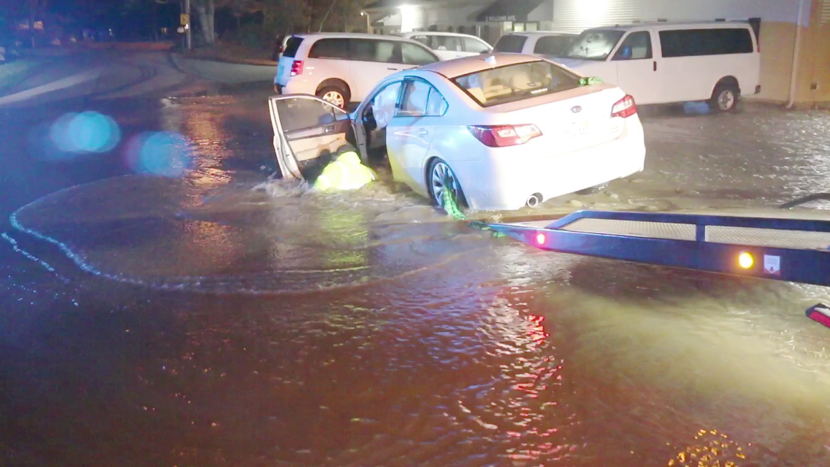 Tow truck driver falls into sinkhole after car hits fire hydrant