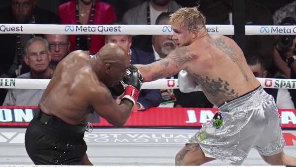 Mike Tyson, left, fights Jake Paul during their heavyweight boxing match, Friday, Nov. 15, 2024, in Arlington, Texas.