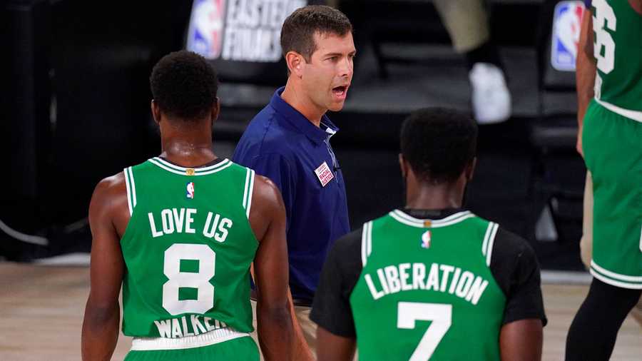 Boston Celtics coach Brad Stevens gestures as he talks with Kemba Walker, left, and Jaylen Brown during a timeout in the first half of Game 4 of the team's NBA basketball Eastern Conference final against the Miami Heat on Wednesday, Sept. 23, 2020, in Lake Buena Vista, Fla. (AP Photo/Mark J. Terrill)