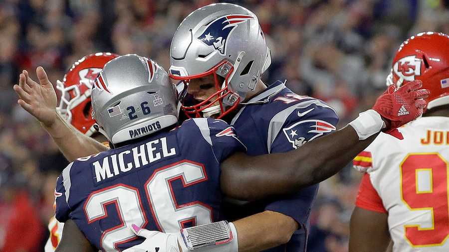 New England Patriots quarterback Tom Brady, right, celebrates a rushing touchdown by running back Sony Michel (26) during the first half of an NFL football game against the Kansas City Chiefs, Sunday, Oct. 14, 2018, in Foxborough, Mass.
