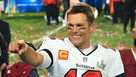 New England Patriots TE Rob Gronkowski (C) folds up the Vince Lombardi  Trophy with Tom Brady (R) after defeating the Seattle Seahawks 28-24 to win  Super Bowl XLIX at University of Phoenix