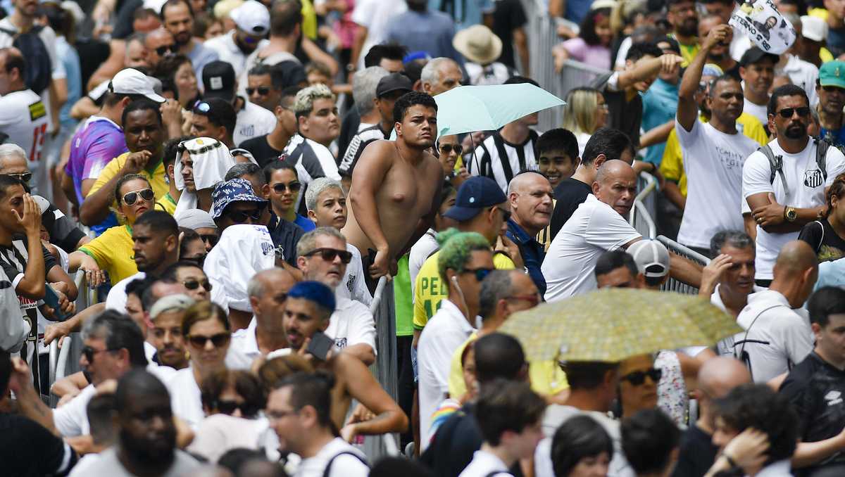 Torcedores lamentam Pelé durante cerimônia pública no estádio Brasil