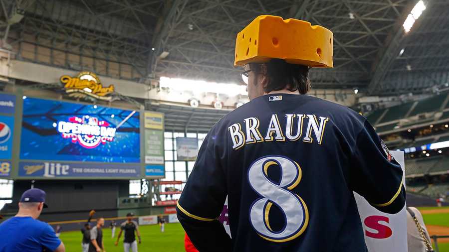A fan watches pre-game activity inside Miller Park before an opening day baseball game between the Colorado Rockies and Milwaukee Brewers Monday, April 3, 2017, in Milwaukee.