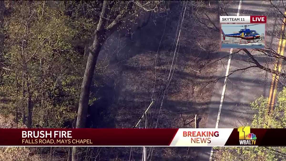 Firefighters battle brush fire on Falls Road; live wires down