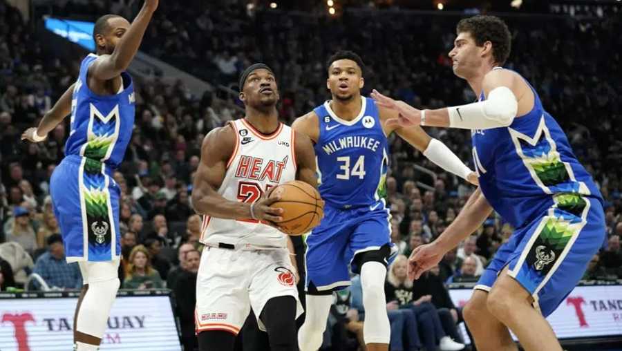 miami heat's jimmy butler, middle, drives to the basket between milwaukee bucks' khris middleton, giannis antetokounmpo, and brook lopez during the first half of an nba basketball game saturday, feb. 4, 2023, in milwaukee. (ap photo/aaron gash)