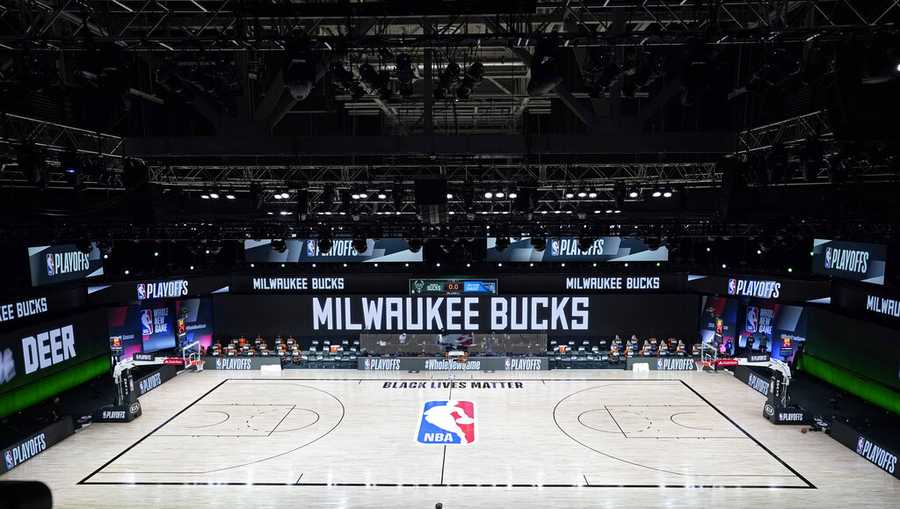 The court and benches are empty of players and coaches at the scheduled start of an NBA basketball first round playoff game between the Milwaukee Bucks and the Orlando Magic, Wednesday, Aug. 26, 2020, in Lake Buena Vista, Fla. (AP Photo/Ashley Landis, Pool)