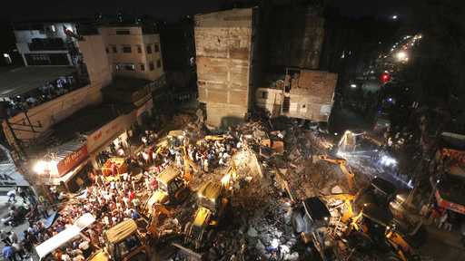 Rescuers work on the debris after a rickety hotel building collapsed in Indore, Madhya Pradesh state, India.