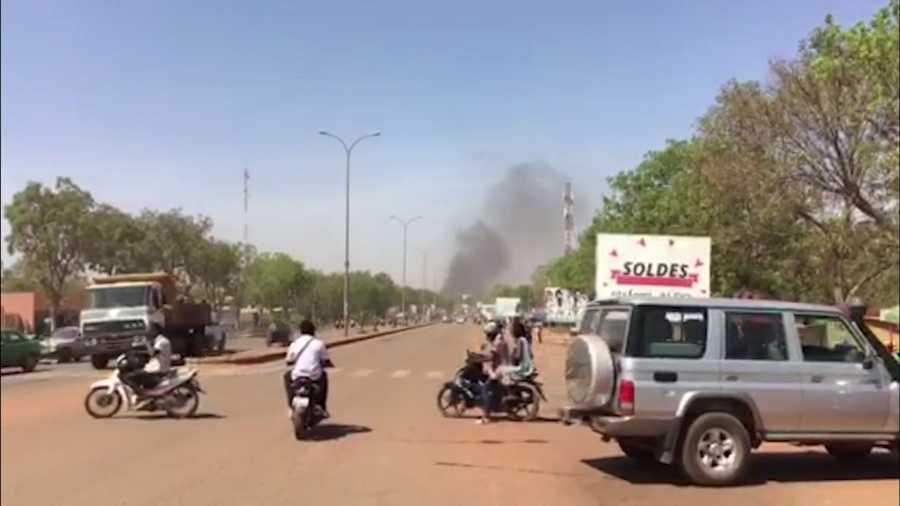 Smoke rises in the background in Ouagadougou, Burkina Faso in this image taken from video Friday March 2, 2018. 